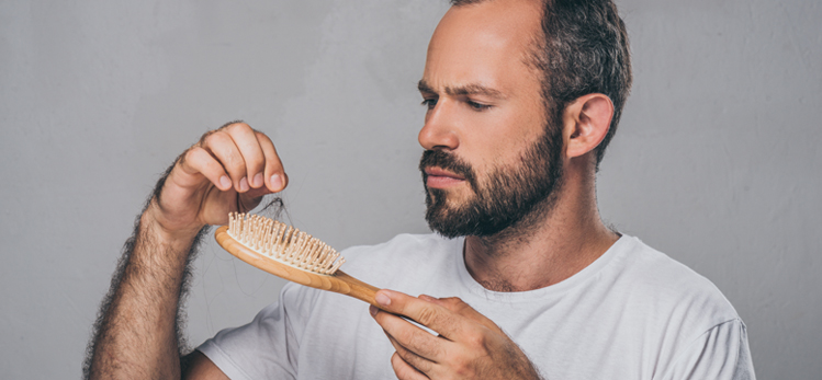 bearded-middle-aged-man-holding-hairbrush